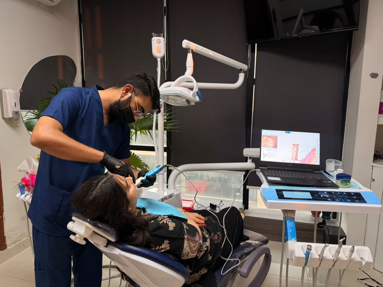Dr. Mamoon Pasha treating a patient at M M Dental Associates